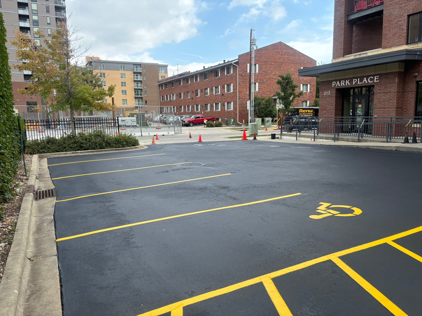 Urban commercial parking lot sealcoating and yellow striping in Wisconsin