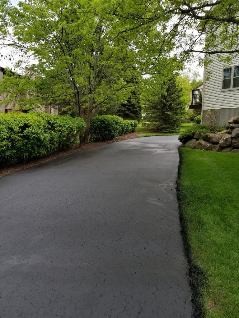 Curved residential driveway after sealcoating in Madison, WI