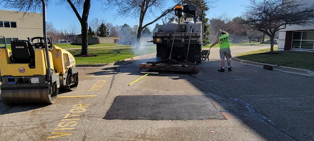Renu Sealcoating crew performing infrared asphalt patching in Madison, WI