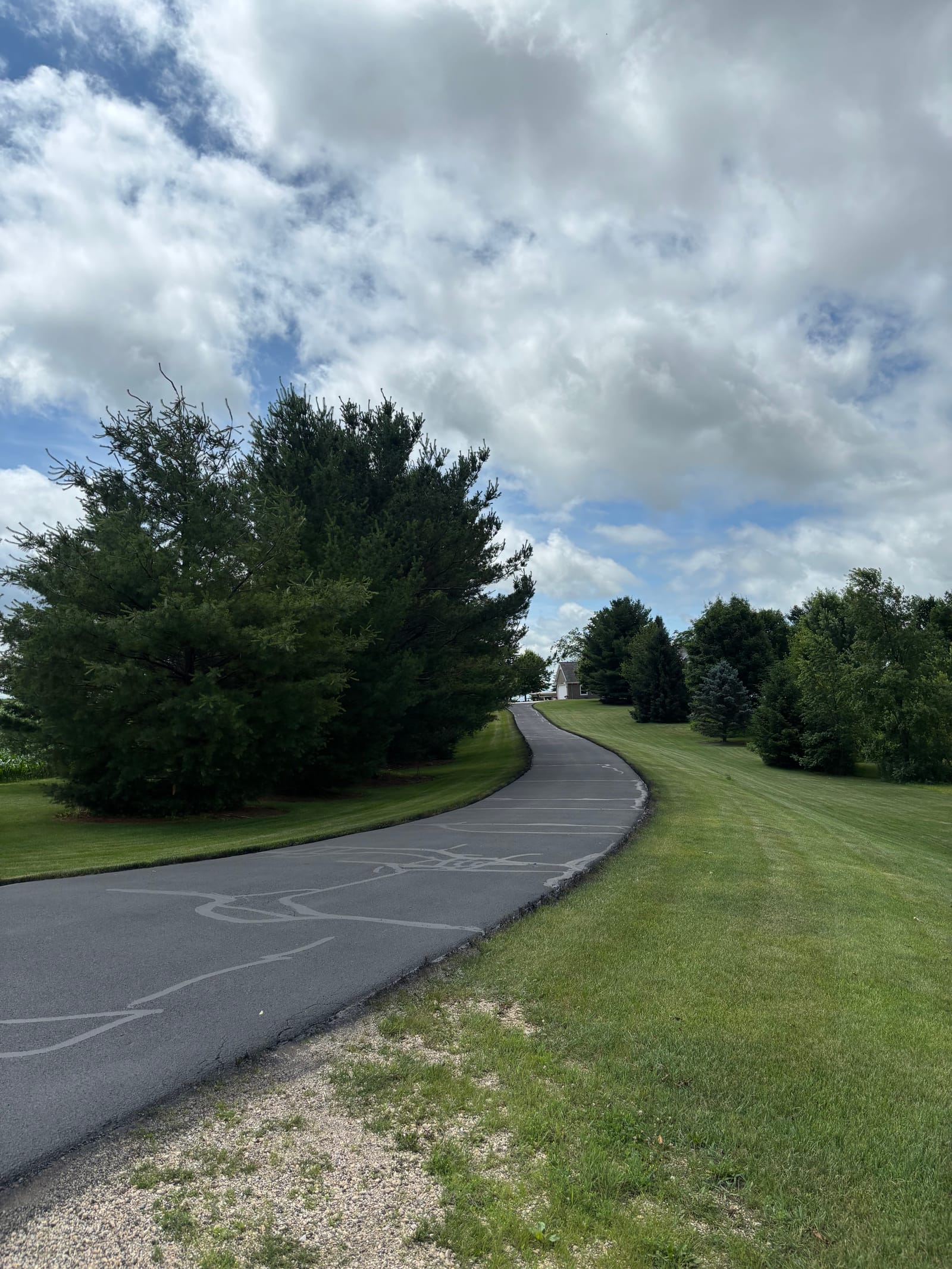 Long country driveway sealcoating in rural Wisconsin