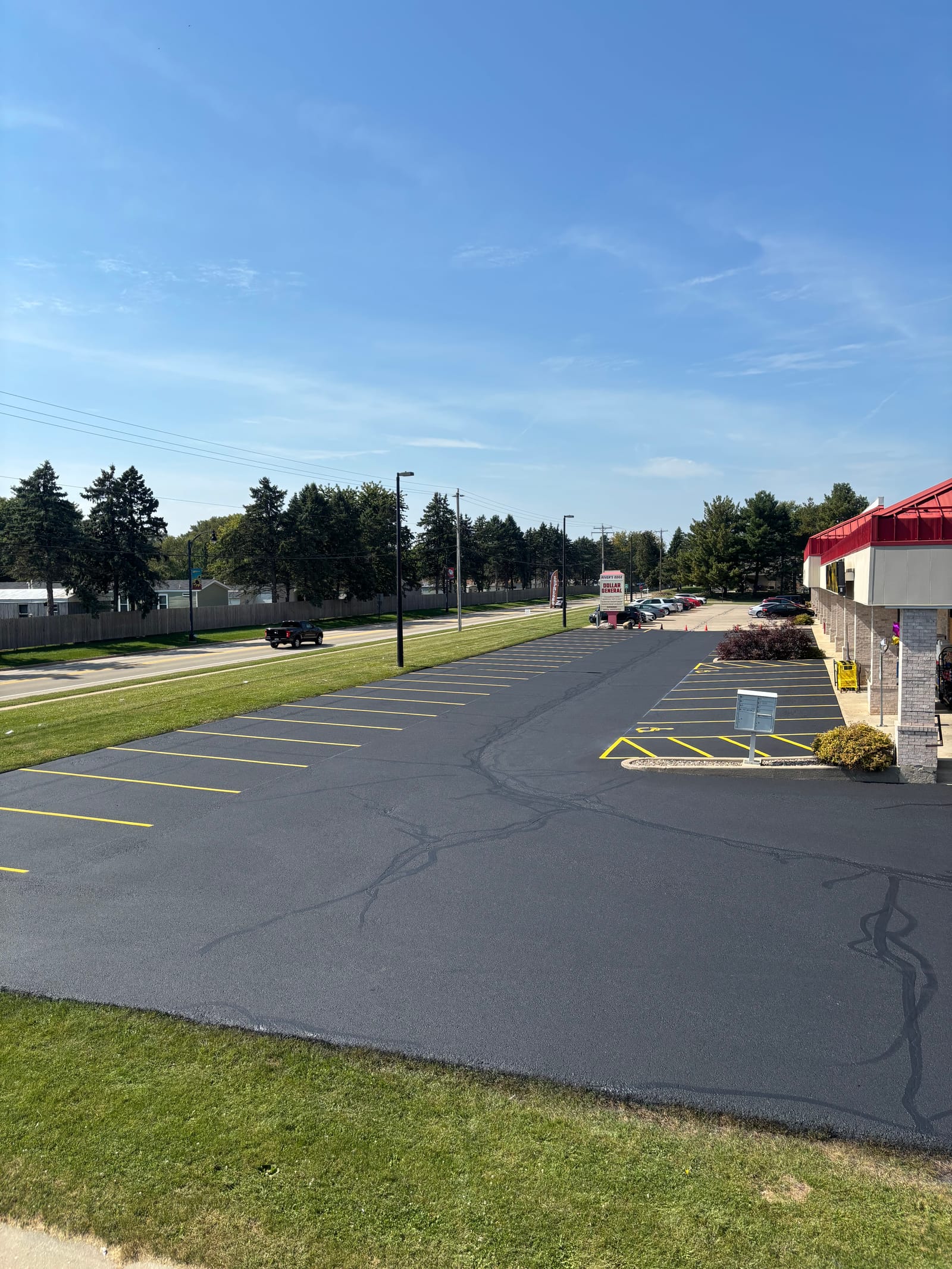 Long winding residential driveway after sealcoating in Madison, WI