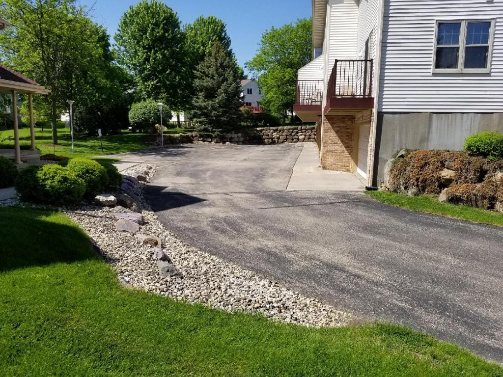 New asphalt driveway with decorative gravel edging in Madison, WI