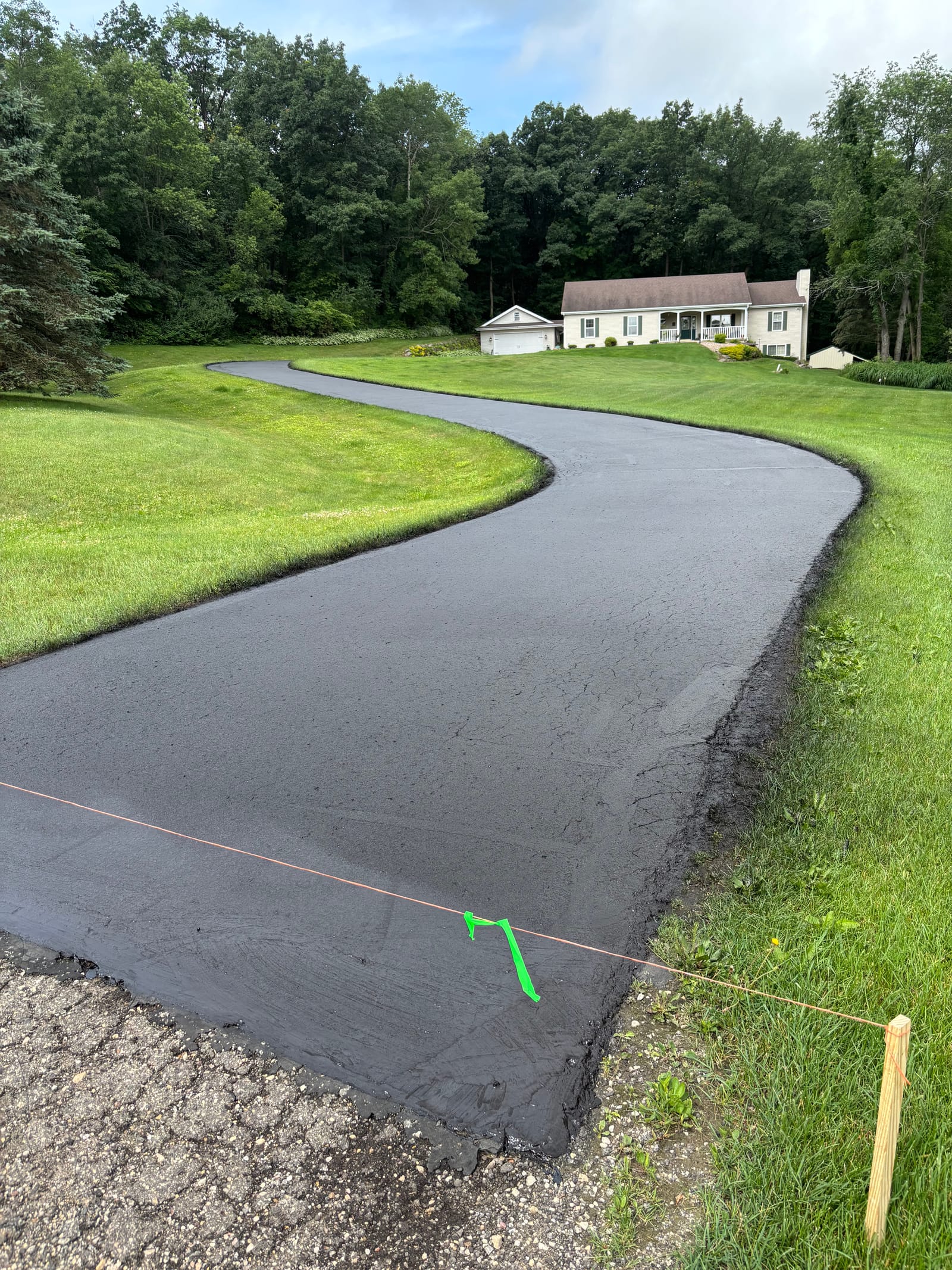 Residential driveway crack filling and fresh sealcoating in Wisconsin
