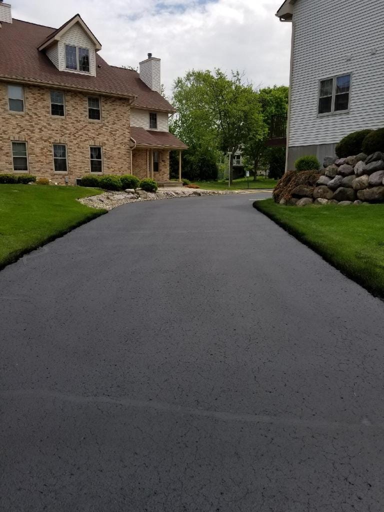 Sealcoated driveway leading to stone house in Madison, WI
