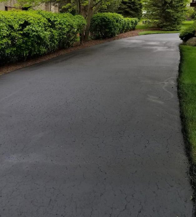 Sealcoated condo driveway showing smooth even coat coverage