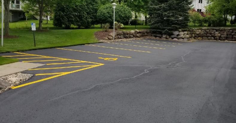 Yellow parking lot line striping with handicap markings in Madison, WI